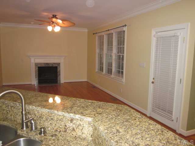 10024 Baileywick Road Raleigh, NC 27613 - Photo 17 of 25 Here is a great shot of the family room taken from the kitchen! Family room features gas log fireplace with marble surround, eyeball lights, ceiling fan with light kit and hardwood floors!
