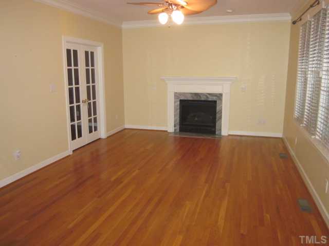 10024 Baileywick Road Raleigh, NC 27613 - Photo 18 of 25 Another nice view of the family room! Beautiful hardwood floors throughout the first floor! Gas log fireplace and ceiling fan with light kit!