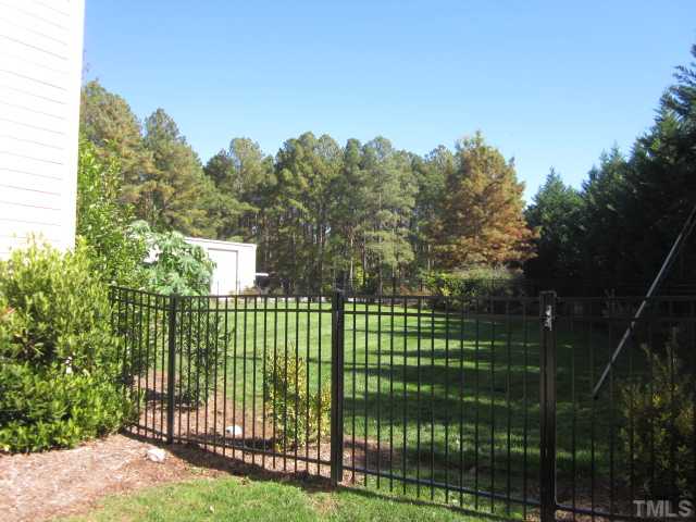 10024 Baileywick Road Raleigh, NC 27613 - Photo 7 of 25 Great custom home in wonderful location! Minutes to 540, I40, RTP, RDU, Falls Lake and so much more! Property line goes past fence into woods! Wonderful fresh landscape and beautiful Leland Cypress trees!