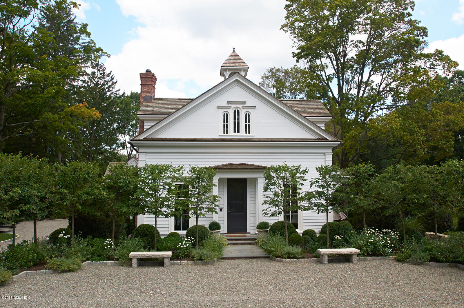 409 Round Hill Road Greenwich, CT 06831 - Photo 1 of 17 a front view of a house with garden