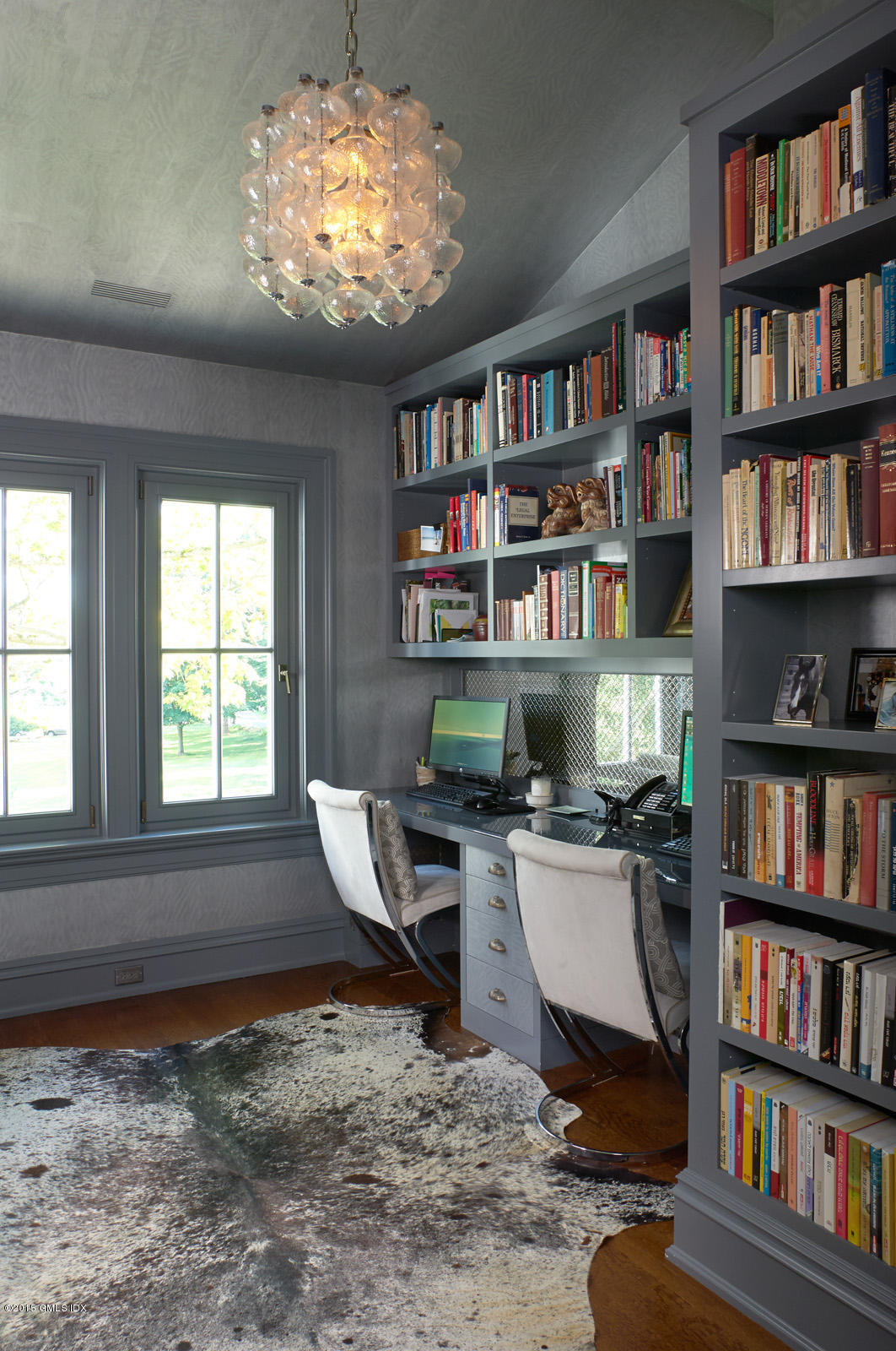 409 Round Hill Road Greenwich, CT 06831 - Photo 12 of 17 a workspace with a book shelf and a window