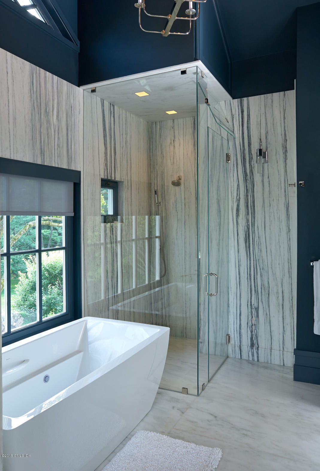 409 Round Hill Road Greenwich, CT 06831 - Photo 13 of 17 a bathroom with a bathtub and a shower