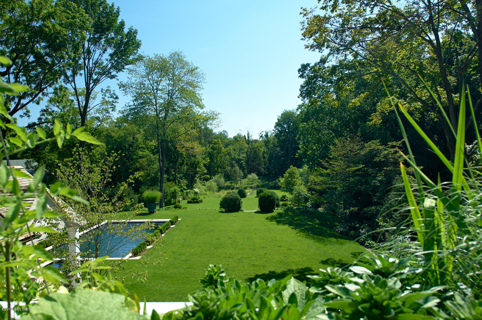409 Round Hill Road Greenwich, CT 06831 - Photo 17 of 17 a view of a garden with a flower