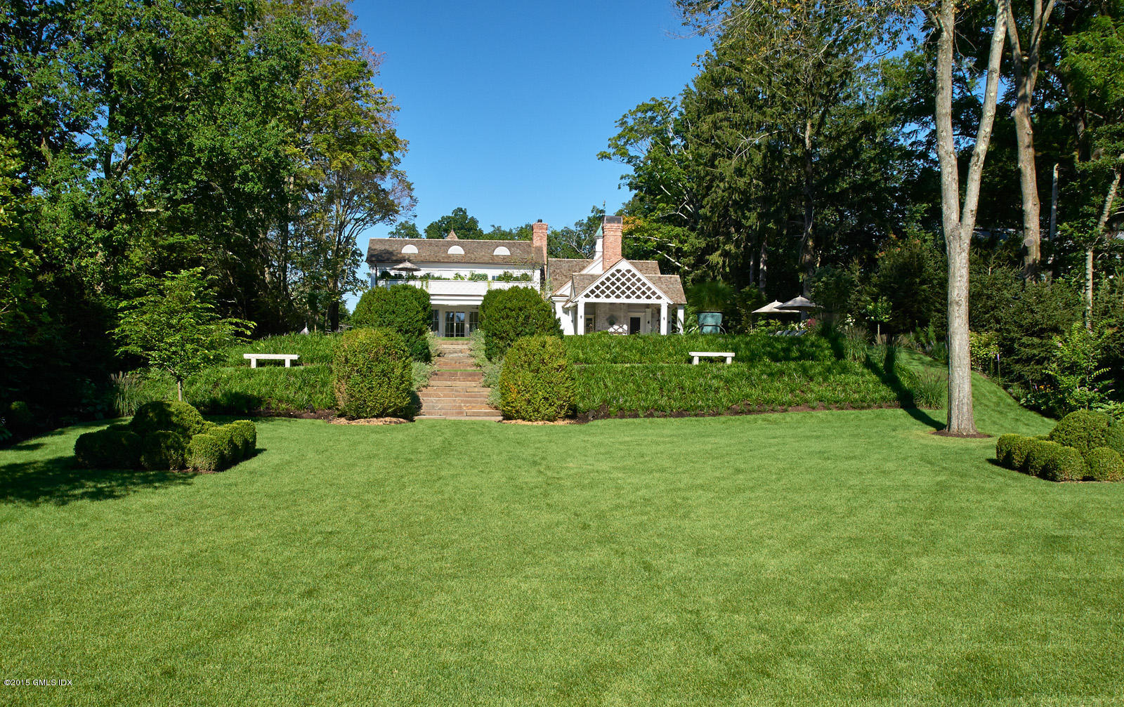 409 Round Hill Road Greenwich, CT 06831 - Photo 4 of 17 a view of a house with a big yard plants and large trees