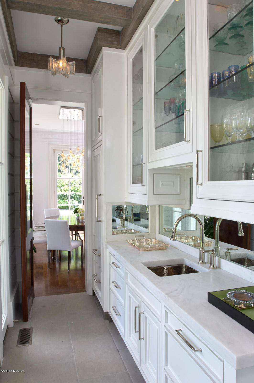 409 Round Hill Road Greenwich, CT 06831 - Photo 8 of 17 a kitchen that has a lot of white cabinets and wooden floor