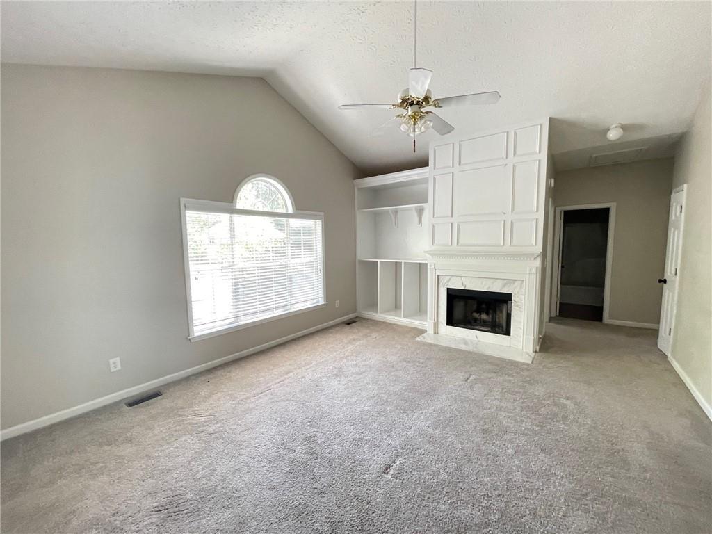 95 Luke Drive Dallas, GA 30132 - Photo 7 of 15 an empty room with windows and fireplace