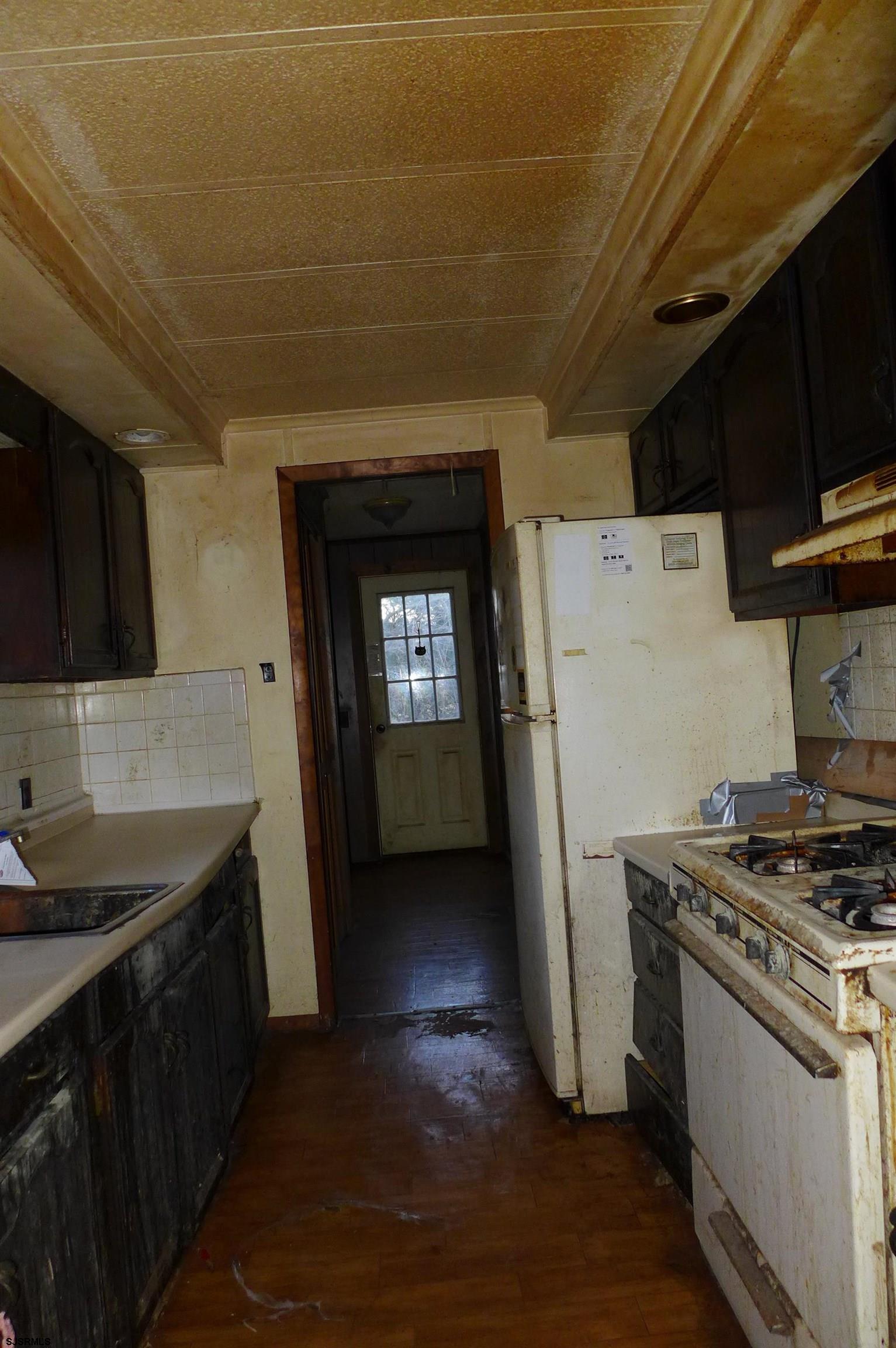 8730 Ferry Road Millville, NJ 08332 - Photo 12 of 14 a kitchen with a sink a stove and refrigerator
