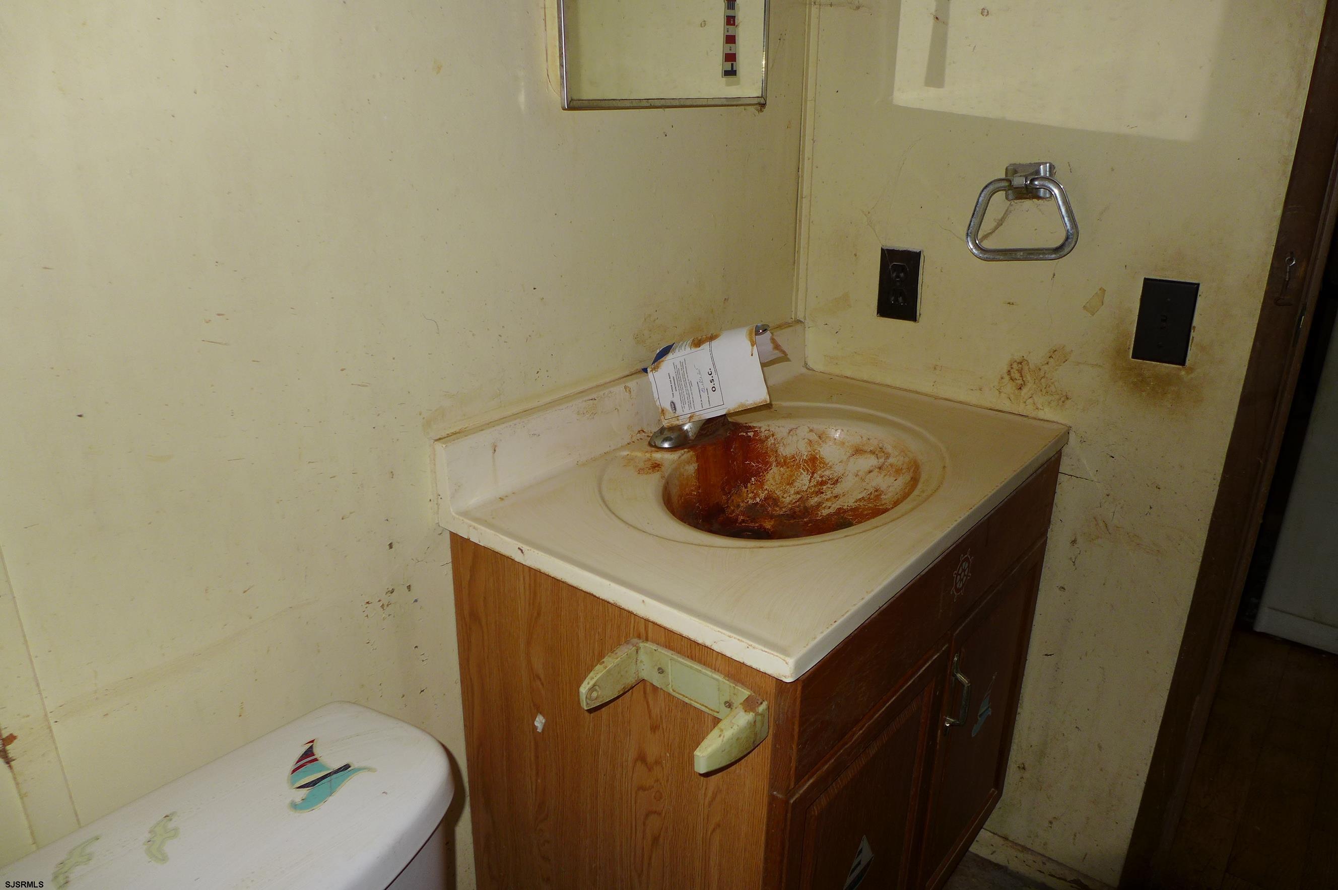 8730 Ferry Road Millville, NJ 08332 - Photo 14 of 14 a bathroom with a sink a toilet and vanity