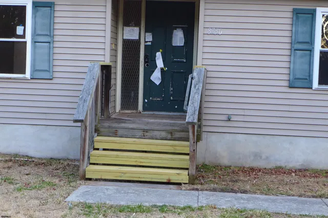 a view of wooden door and a window