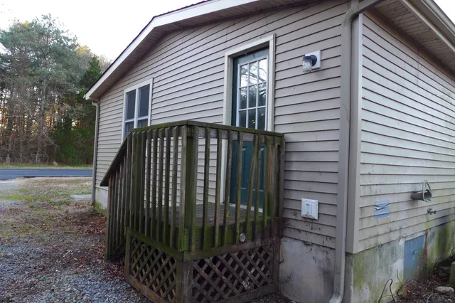 a view of a house with backyard and trees