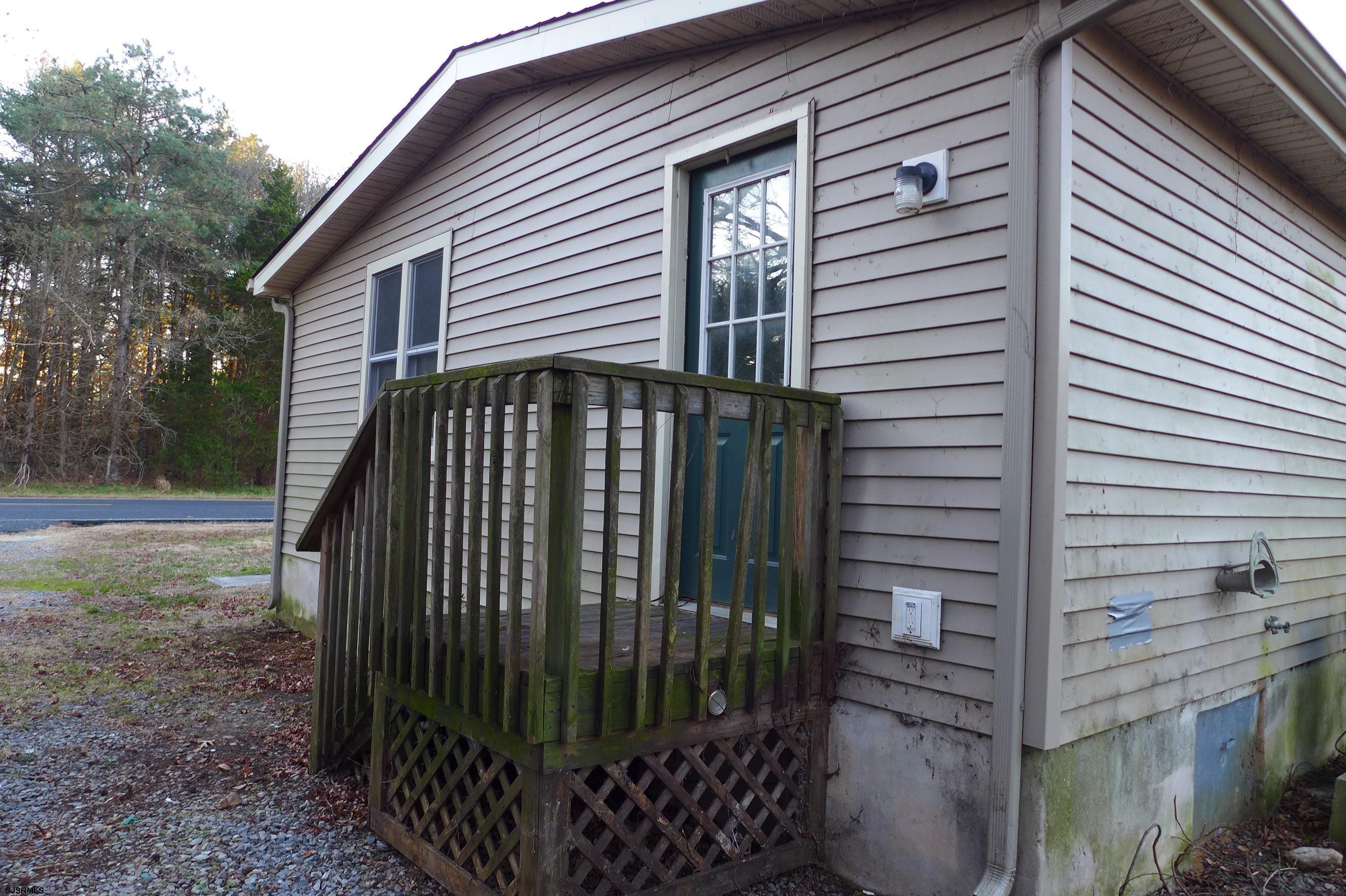 8730 Ferry Road Millville, NJ 08332 - Photo 5 of 14 a view of a house with backyard and trees