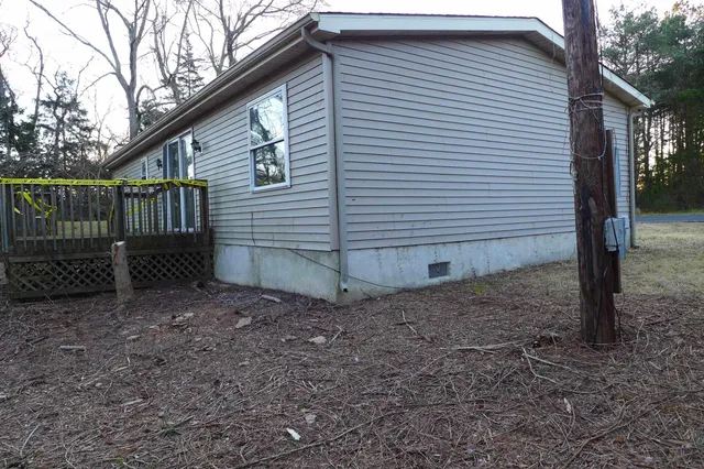 a view of a house with a yard and wooden fence
