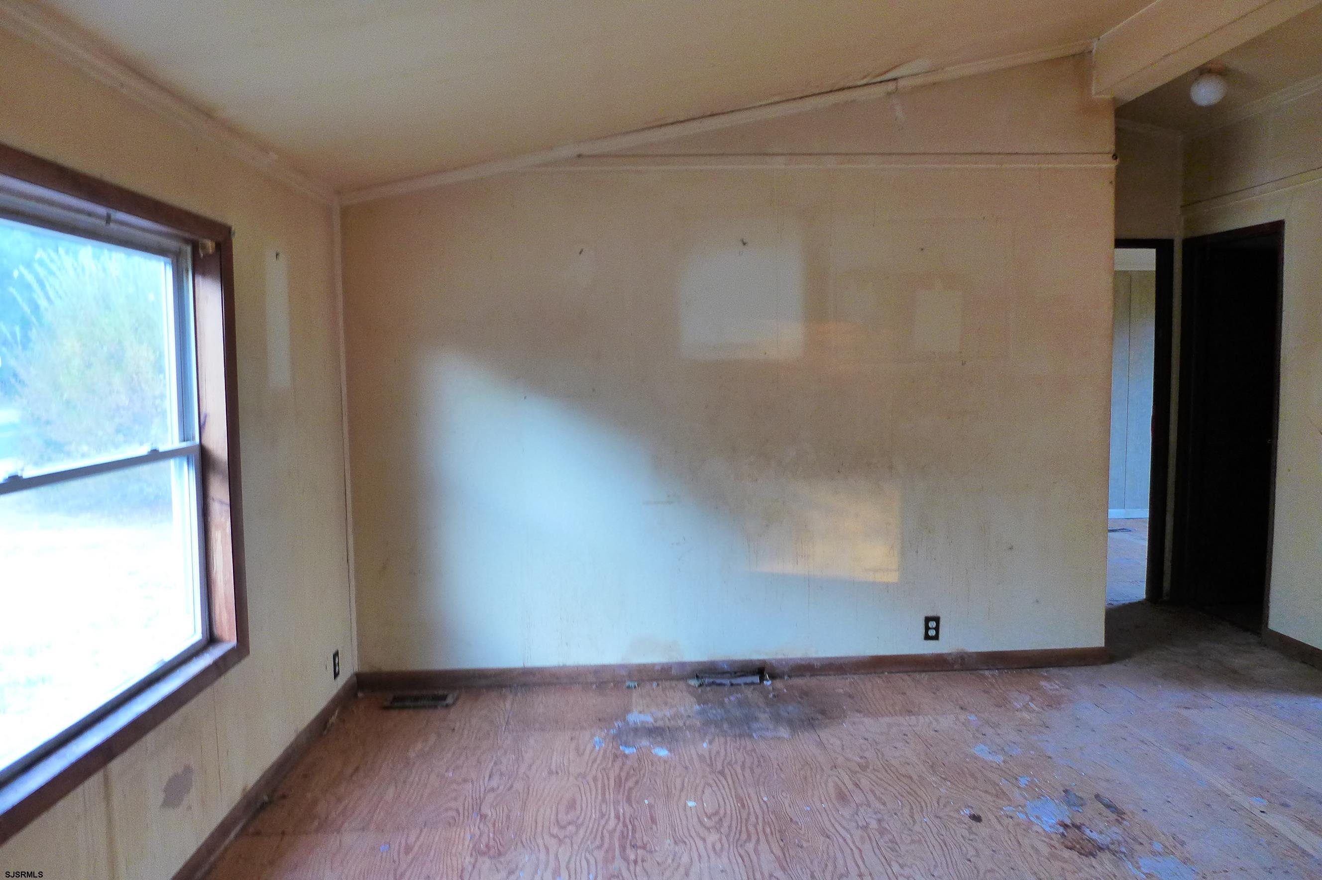 8730 Ferry Road Millville, NJ 08332 - Photo 7 of 14 a view of an empty room with a window