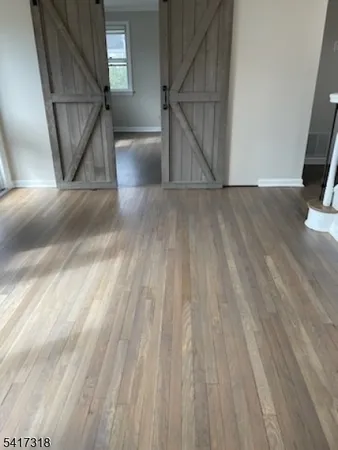 a view of entryway and wooden floor