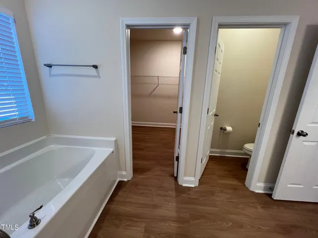 a bathroom with a tub and a shower