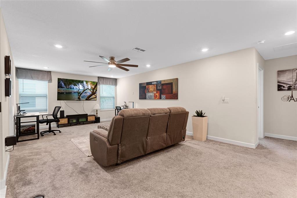 1089 Blackwolf Run Road Davenport, FL 33896 - Photo 24 of 82 a living room with furniture and a flat screen tv