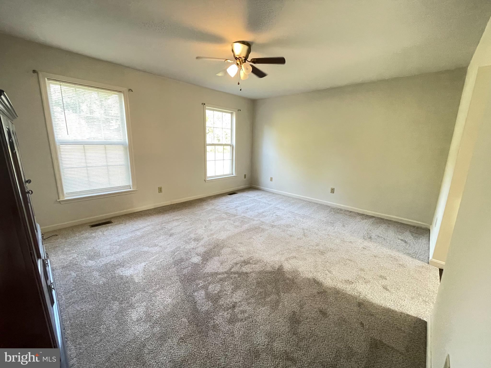 10197 Madison Drive King George, VA 22485 - Photo 11 of 19 an empty room with windows and a ceiling fan