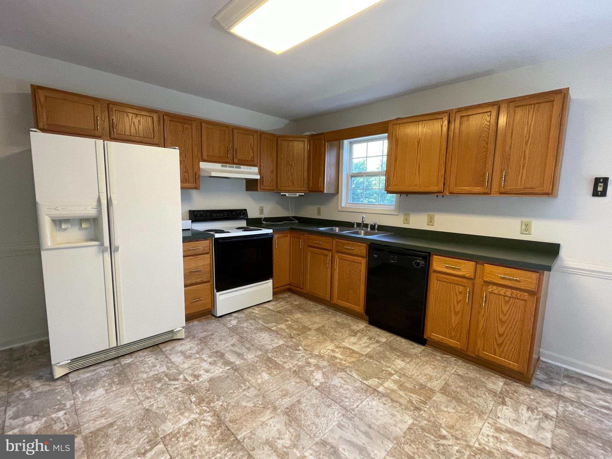 10197 Madison Drive King George, VA 22485 - Photo 6 of 19 a kitchen with stainless steel appliances granite countertop a stove a sink dishwasher and a refrigerator