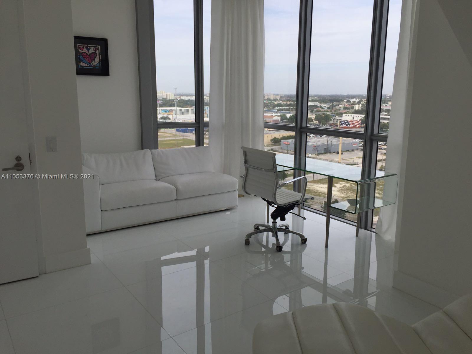 1100 Biscayne Boulevard, Unit 1505 Miami, FL 33132 - Photo 14 of 15 a living room with furniture and a floor to ceiling window