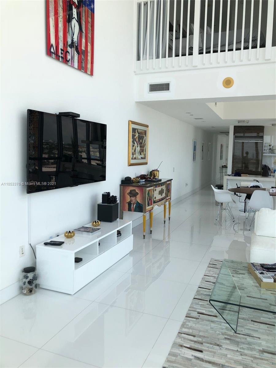 1100 Biscayne Boulevard, Unit 1505 Miami, FL 33132 - Photo 7 of 15 a living room with stainless steel appliances kitchen island granite countertop a stove a sink and a microwave