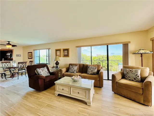 a living room with furniture and a floor to ceiling window