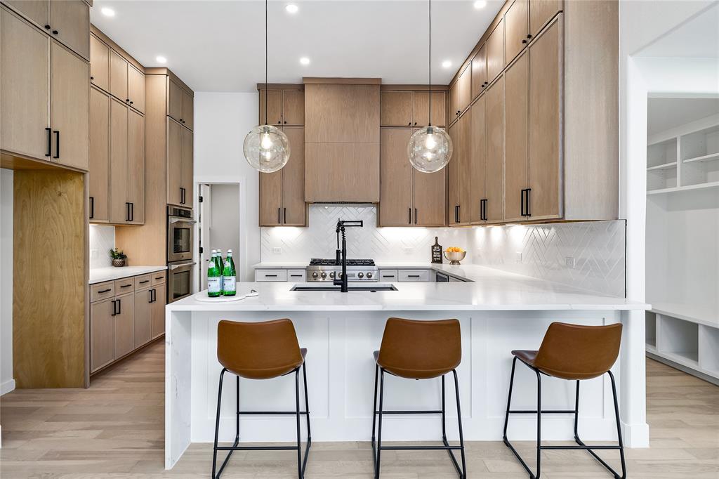 a kitchen with stainless steel appliances kitchen island granite countertop a table and chairs in it
