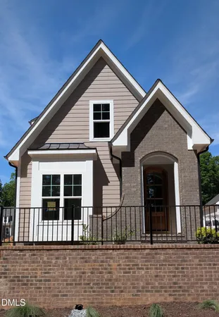 a front view of a house with a small garden
