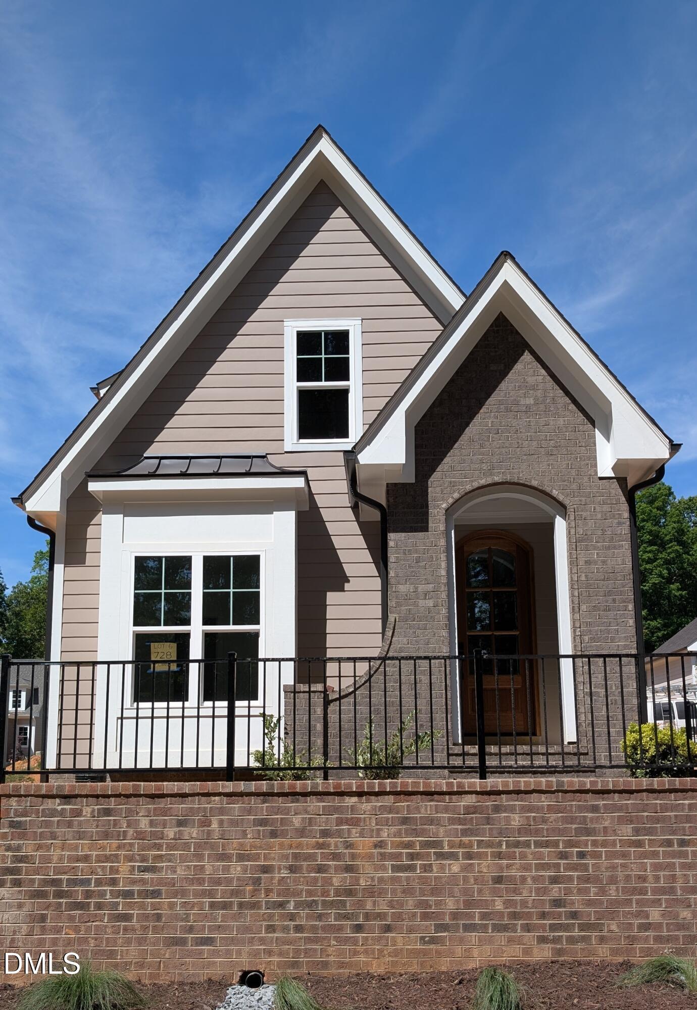 a front view of a house with a small garden