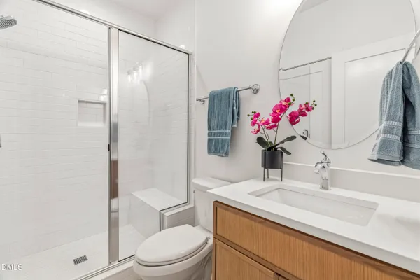 a bathroom with a double vanity sink mirror and shower