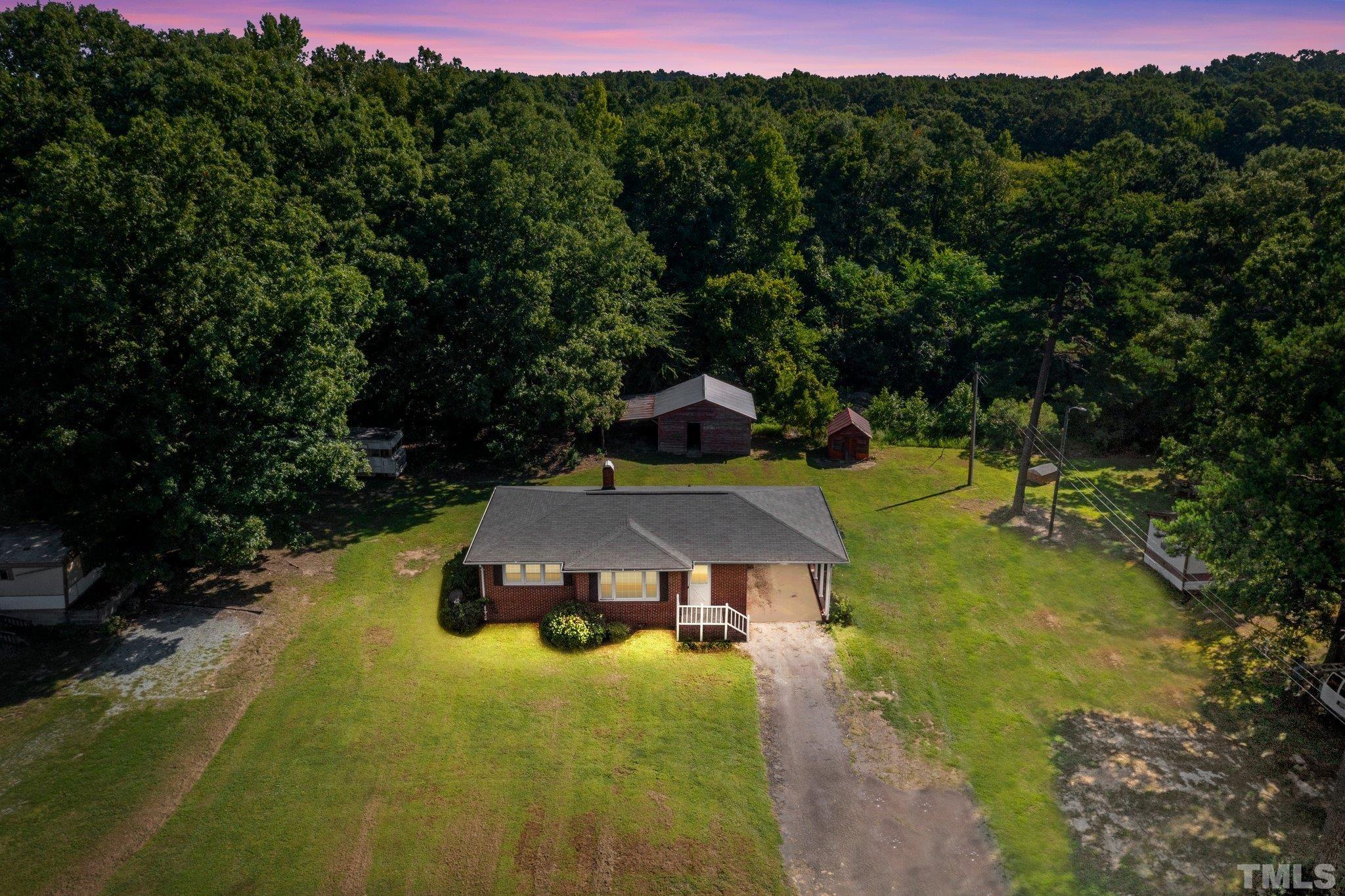 11001 Oxford Road Rougemont, NC 27572 - Photo 2 of 16 a view of a swimming pool with a yard