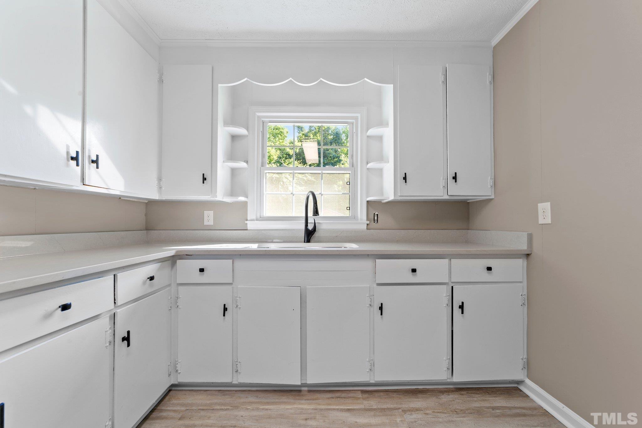 11001 Oxford Road Rougemont, NC 27572 - Photo 5 of 16 a kitchen with white cabinets appliances and a sink