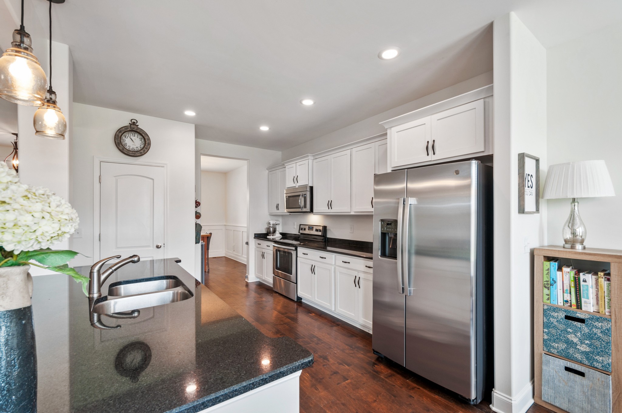 3056 Everleigh Place Spring Hill, TN 37174 - Photo 14 of 43 a kitchen with stainless steel appliances granite countertop a refrigerator a stove and a sink with wooden floor