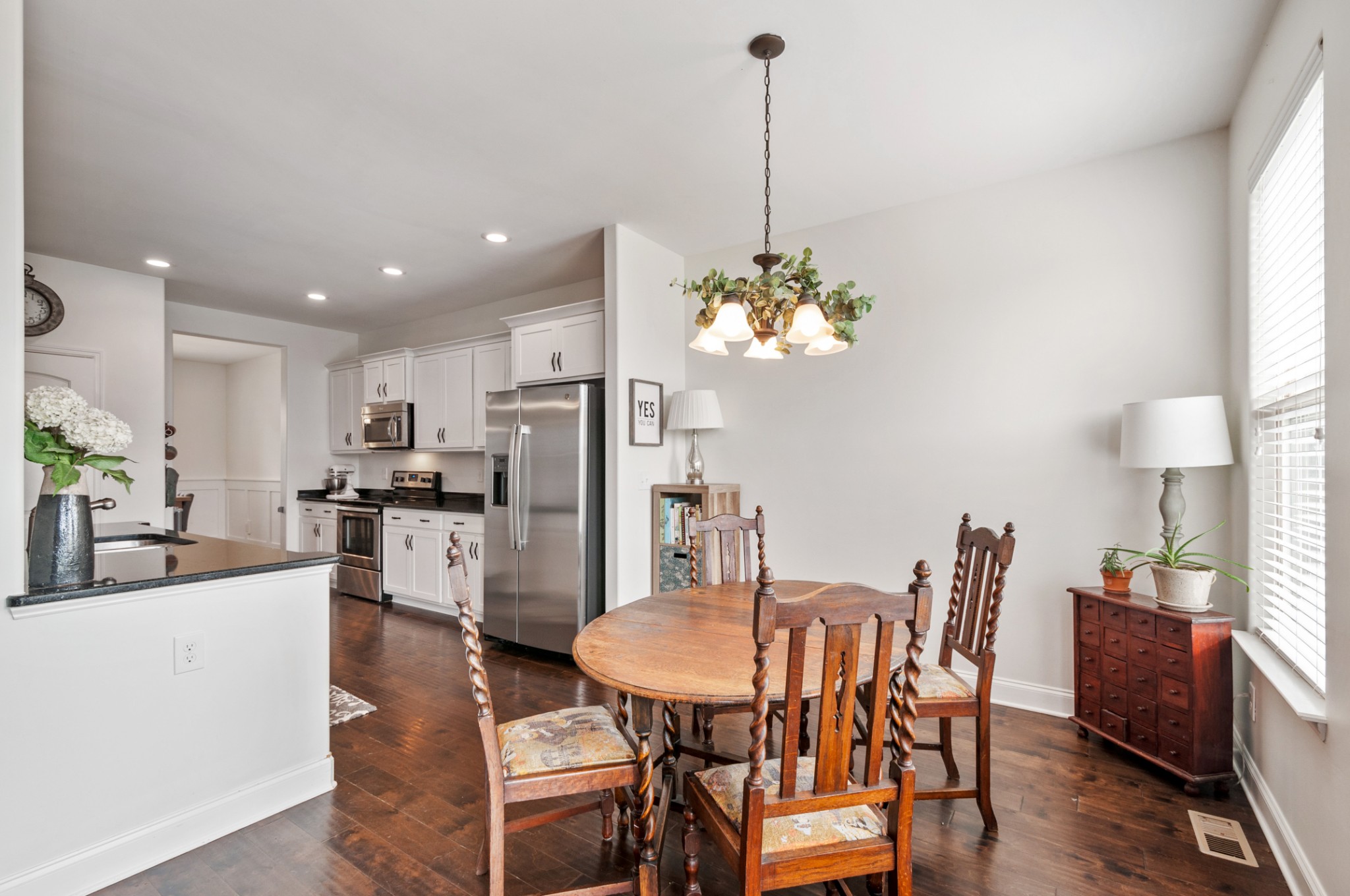 3056 Everleigh Place Spring Hill, TN 37174 - Photo 16 of 43 a view of a dining room and livingroom with furniture wooden floor a chandelier