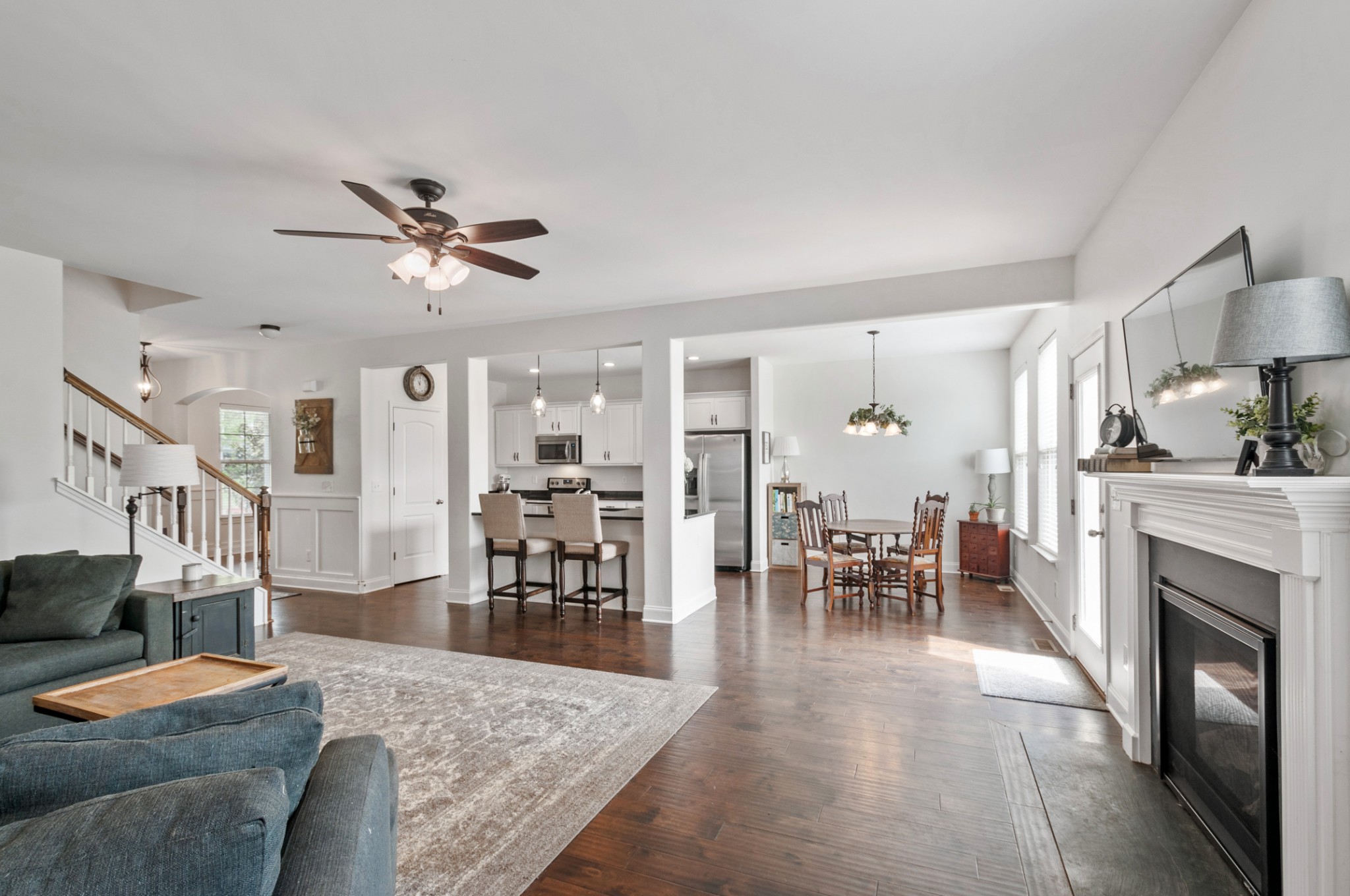 3056 Everleigh Place Spring Hill, TN 37174 - Photo 19 of 43 a living room with furniture a fireplace and a chandelier