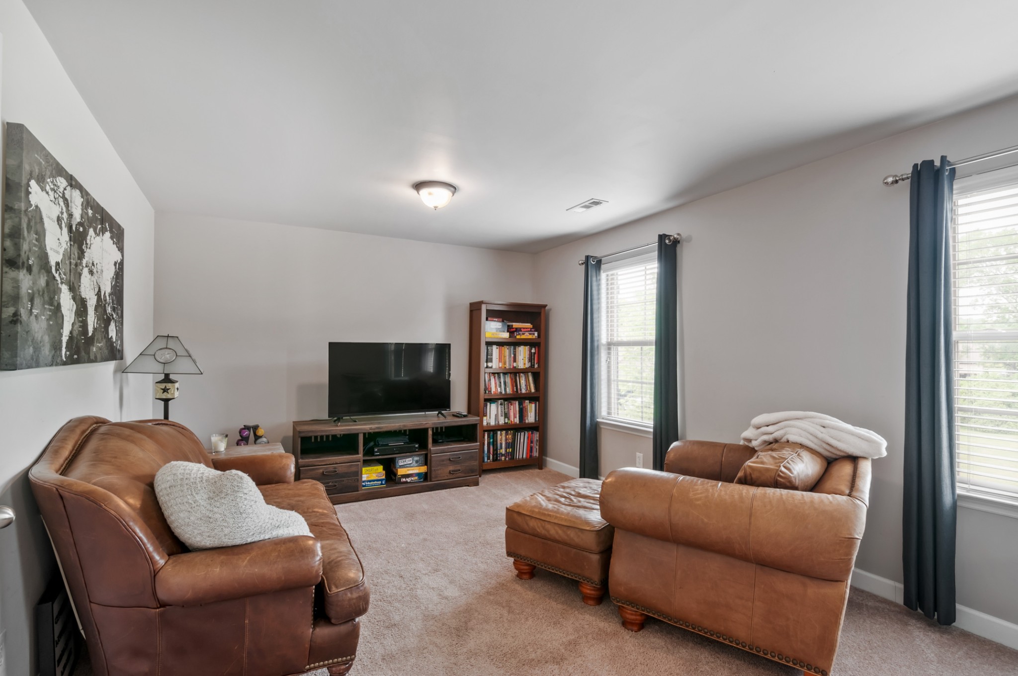 3056 Everleigh Place Spring Hill, TN 37174 - Photo 35 of 43 a living room with furniture and a flat screen tv