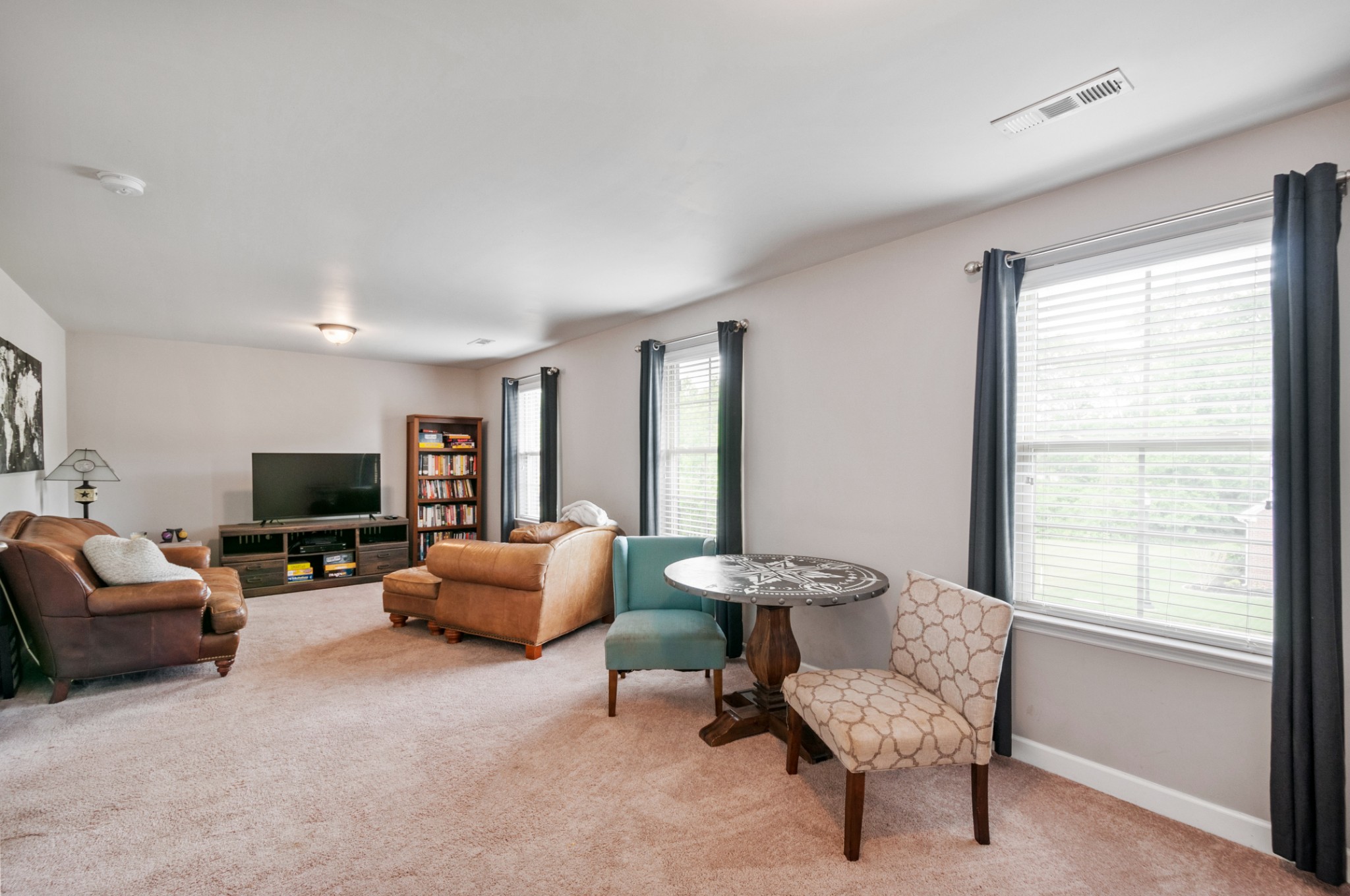 3056 Everleigh Place Spring Hill, TN 37174 - Photo 36 of 43 a living room with furniture and a flat screen tv