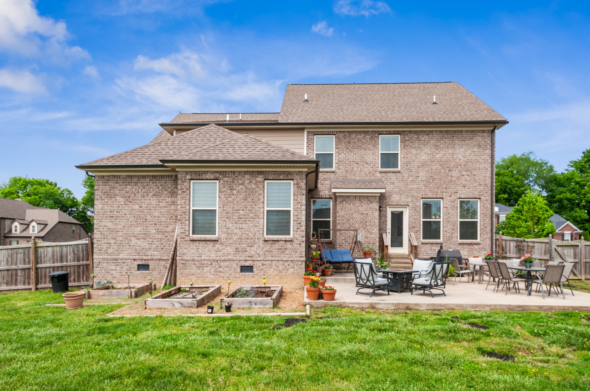 3056 Everleigh Place Spring Hill, TN 37174 - Photo 40 of 43 a front view of a house with garden and trees