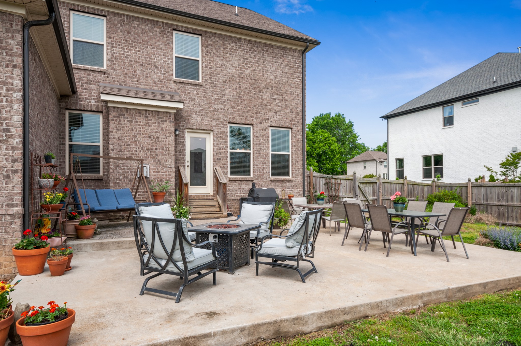 3056 Everleigh Place Spring Hill, TN 37174 - Photo 41 of 43 a view of a patio with table and chairs potted plants and a fire pit