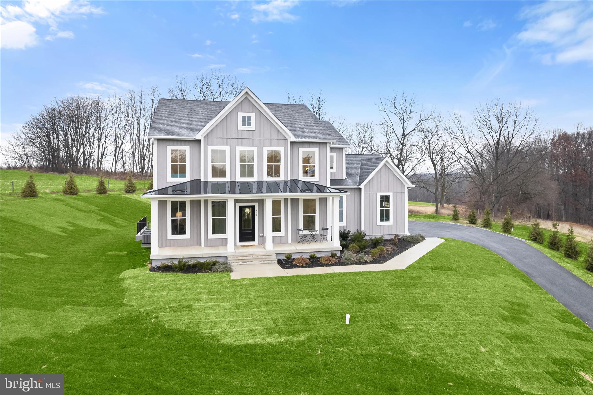a front view of a house with a yard table and chairs