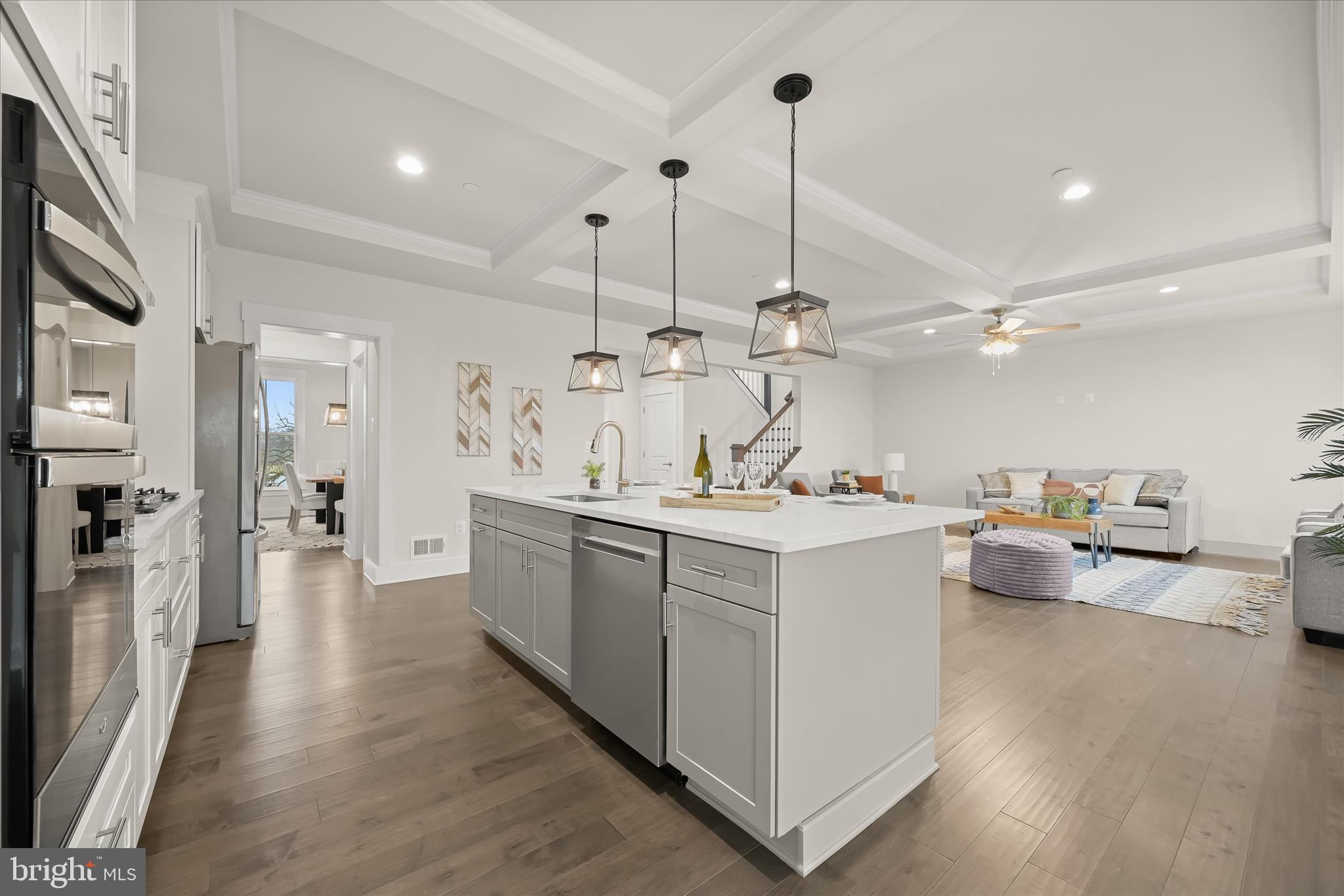 618 Deer Park Road Westminster, MD 21157 - Photo 18 of 57 a large kitchen with kitchen island a white counter space a sink appliances and wooden floor