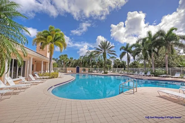 a view of a swimming pool with a lawn chairs