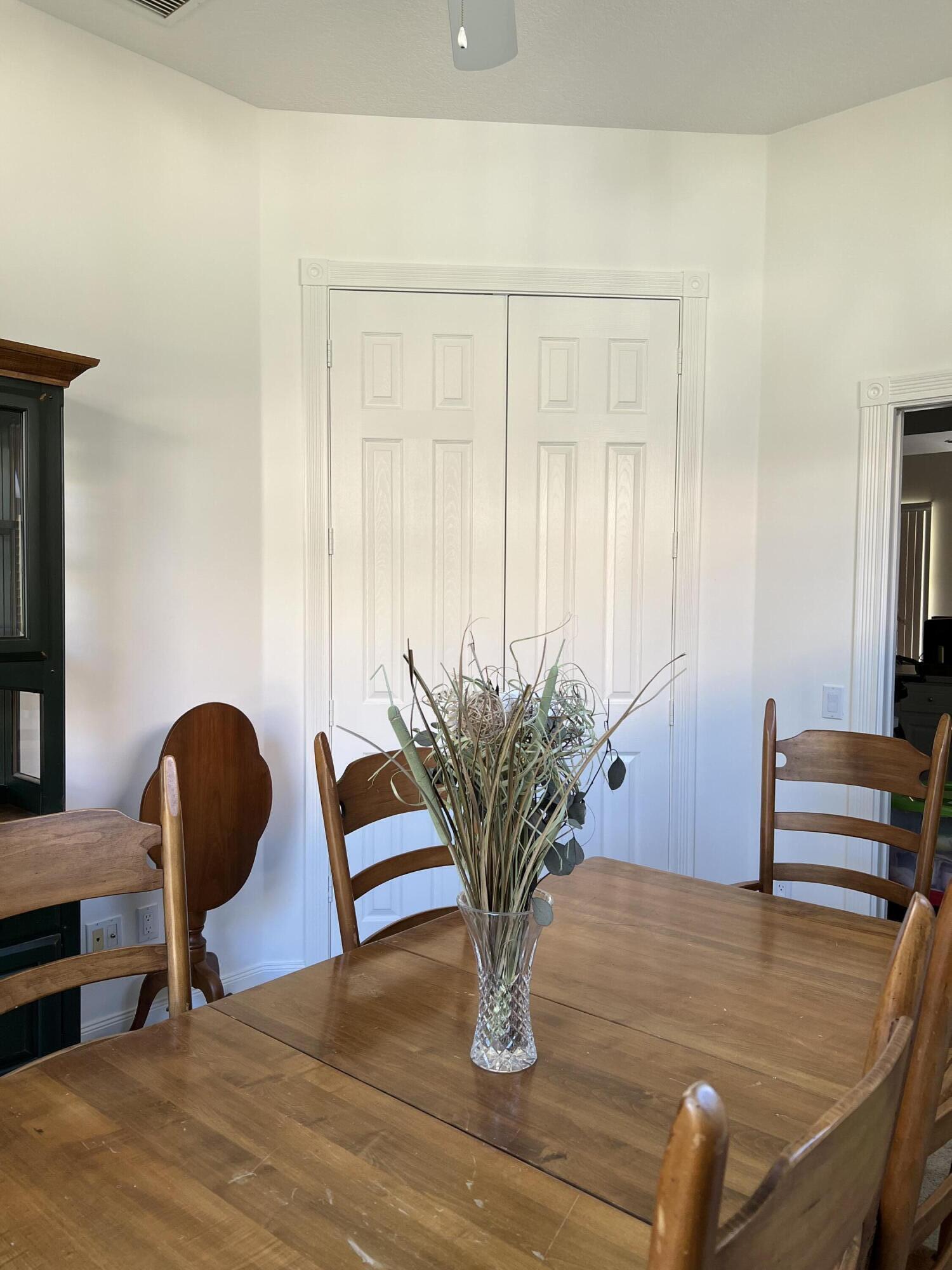 8984 Southeast Hawks Nest Court Hobe Sound, FL 33455 - Photo 18 of 21 a view of a workspace room with furniture and wooden floor