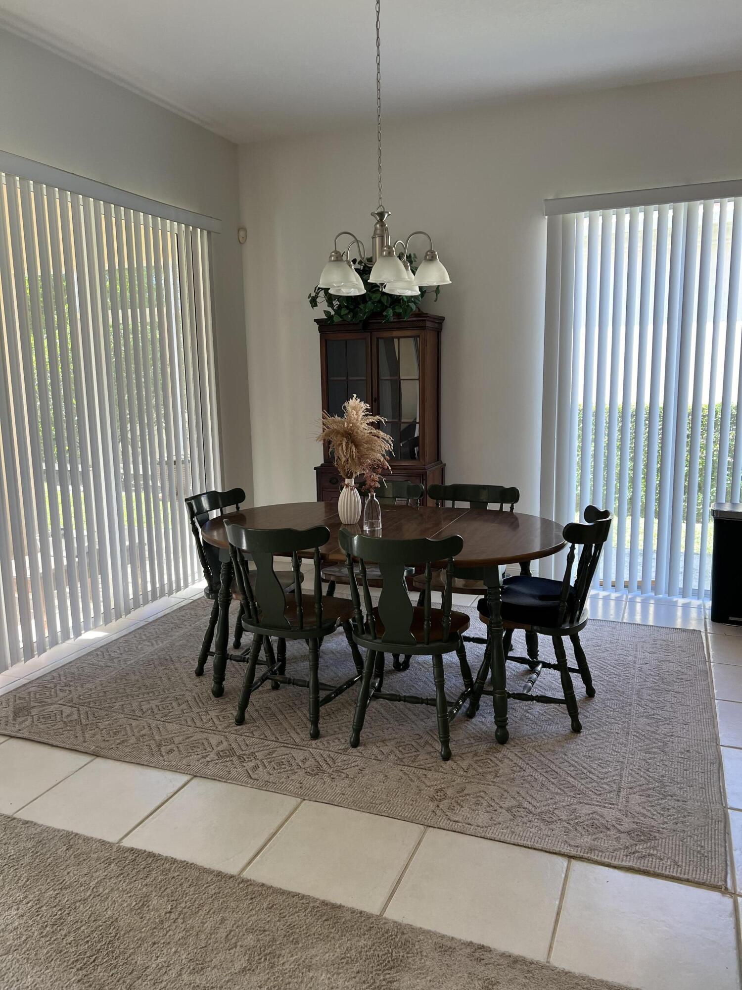 8984 Southeast Hawks Nest Court Hobe Sound, FL 33455 - Photo 19 of 21 a view of a dining room with furniture window and outside view