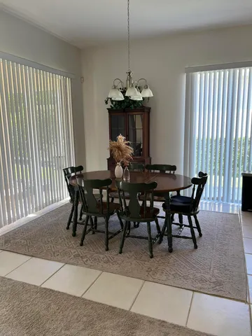 a view of a dining room with furniture window and outside view