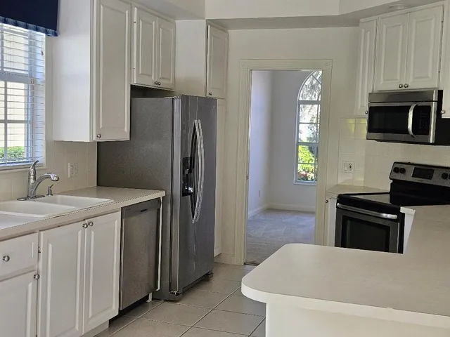 a kitchen with stainless steel appliances a stove a sink and a refrigerator