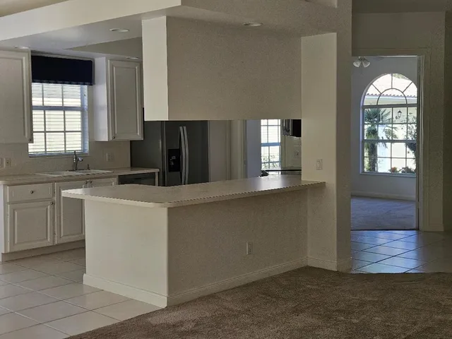 a kitchen with cabinets and window
