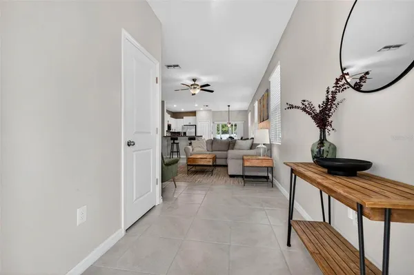 a view of a livingroom with furniture and a hallway