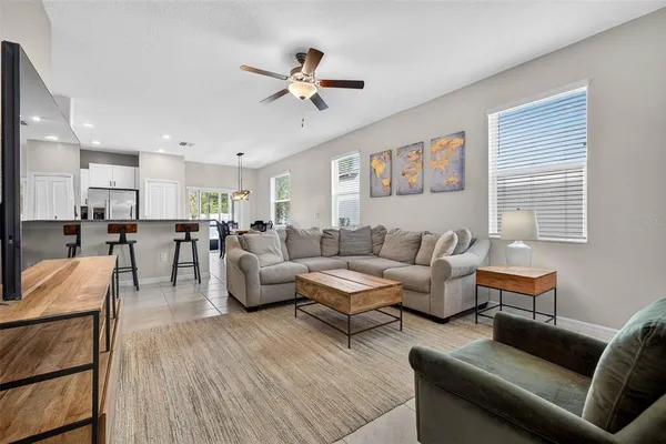 a living room with furniture and a view of kitchen
