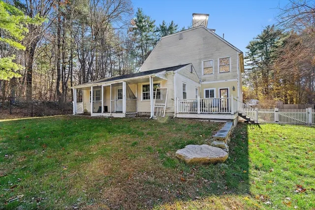 a view of a house with backyard sitting area and garden