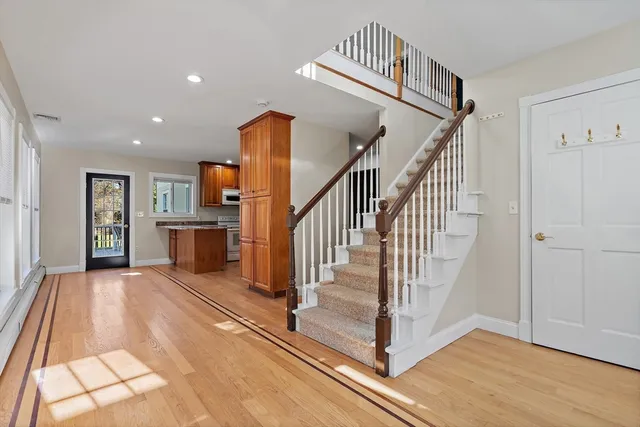 a view of entryway and hall with wooden floor